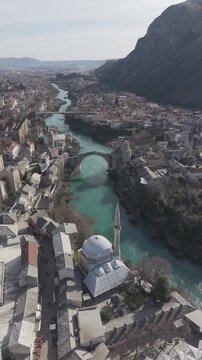 Drone aerial view of Stari Most (Old Bridge) and Koski Mehmed Pasha Mosque in Mostar, Bosnia and Herzegovina