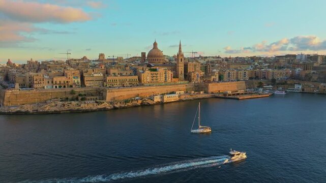 Drone sunset view of Valletta city, capital of Maltese island. Church. Mediterranean sea