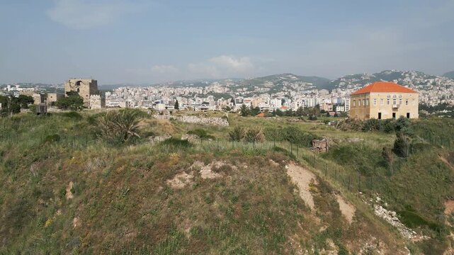 Aerial ascending drone shot showcases historic landmarks of Byblos, Lebanon one of oldest continuously inhabited Mediterranean cities.