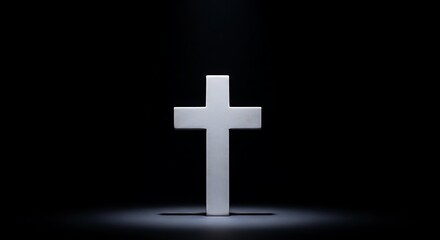 Fototapeta premium White cross illuminated against black background symbolizing faith and hope