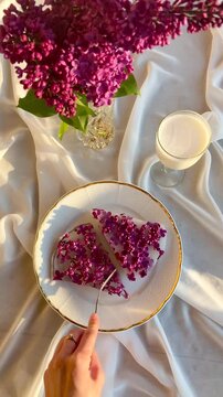 Person slicing soft jelly dessert on a plate close up
