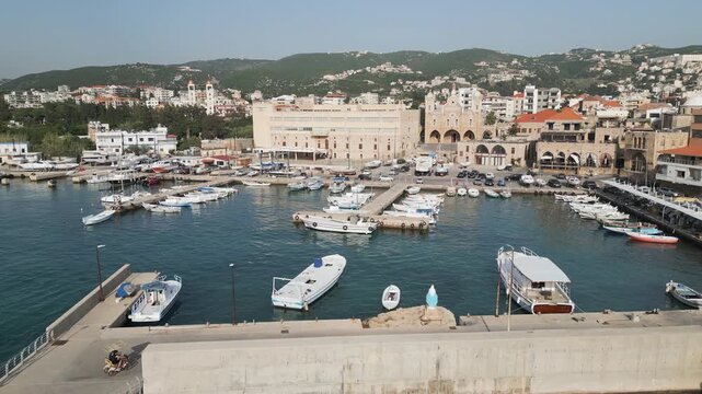 Aerial descending drone video of Batroun sea porta, a historic Mediterranean sea port located in Batroun, northern Lebanon.