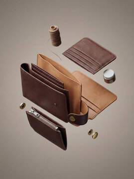 Exploded view of premium leather wallet with outer shell lining card slots zipper coin pocket and snap closure.