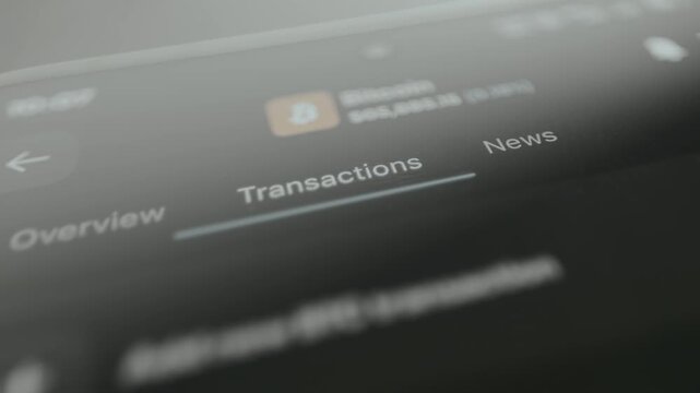 Finger taps the Transactions option within the navigation menu of a cryptocurrency app