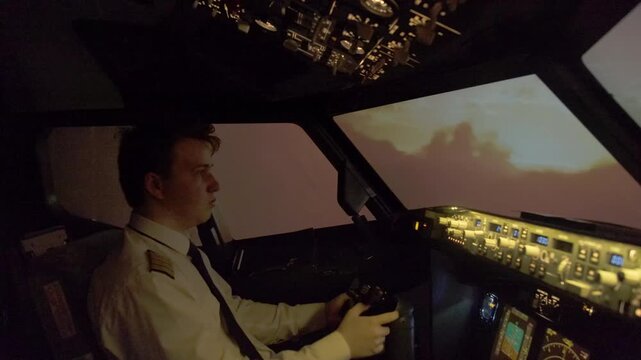 Focused pilot engages in descending phase manipulating control yoke of plane. Captain in uniform navigates plane during lightning