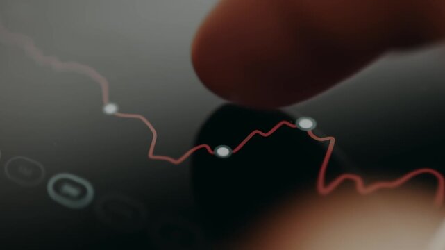 Finger interacting with a linear graph on a dark background