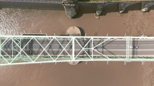 Liverpool, Merseyside, UK, September 09, 2025; aerial 4K video footage of the Silver Jubilee Bridge and Britannia Railway Viaduct over the River Mersey and Manchester Ship Canal, Runcorn, Merseyside