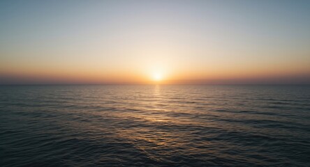 calm oceanfront landscape at sunset with soft glowing sky