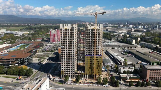 Ascending drone unveils a modern district under development in Ljubljana, Slovenia, new buildings and active construction sites revealing the rapid urban growth of the Slovenian capital.