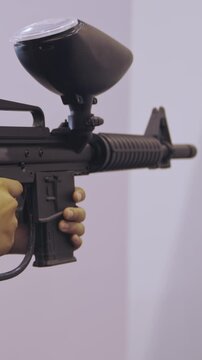 Girl takes aim and shoots airsoft gun
