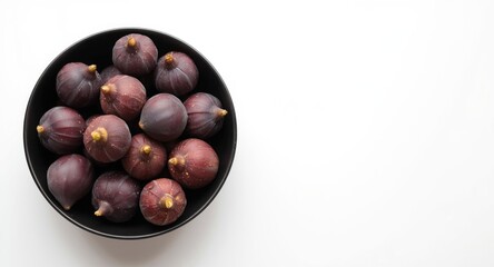 Obraz premium Cluster of fresh purple figs in a sleek black bowl with a neutral white backdrop