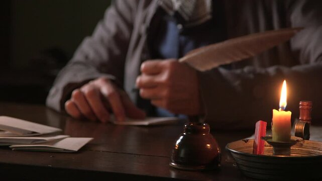 18th century man folding and putting a wax seal on a letter