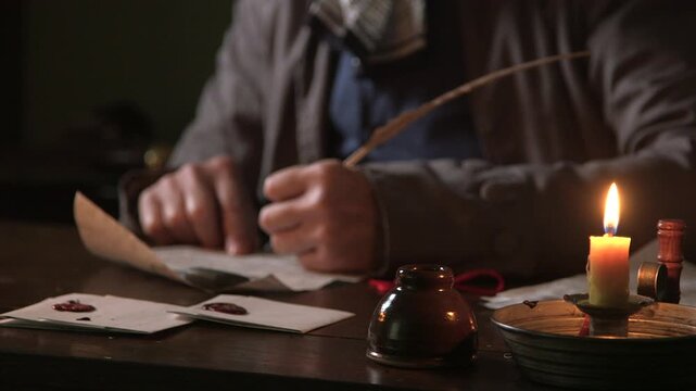 18th century man writing a letter and adding a wax stamp