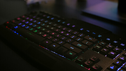 Close-up of professional keyboard with RGB lighting during online gaming tournament. Home studio of esport video game player using powerful gaming PC © DC Studio