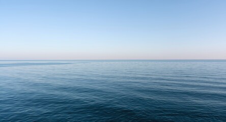 Obraz premium Calm maritime horizon with faint ripple details and clean sky copy space