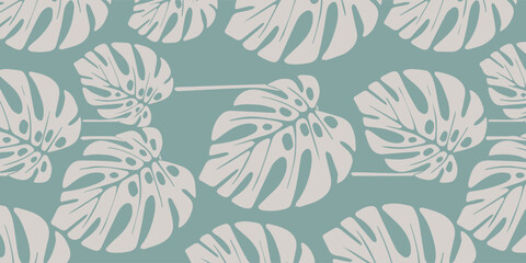 Seamless Pattern with Monstera Leaves on a Green Background. © AsyfaNur