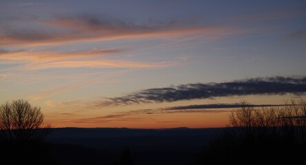 Fototapeta premium Winter evening sky glowing with golden twilight hues