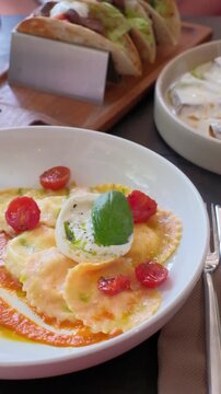 Ravioli tomato sauce main course tasty snack fresh delicious gourmet food on the table rustic food top view copy space. High quality FullHD footage