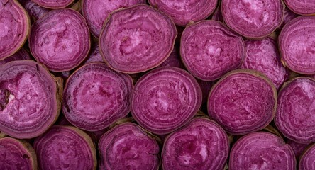 Fototapeta premium Abstract background featuring rough sliced purple sweet potato surface and soft daylight