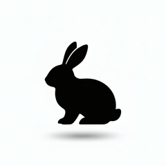 Obraz premium Minimalist black silhouette of a sitting Easter rabbit on white background
