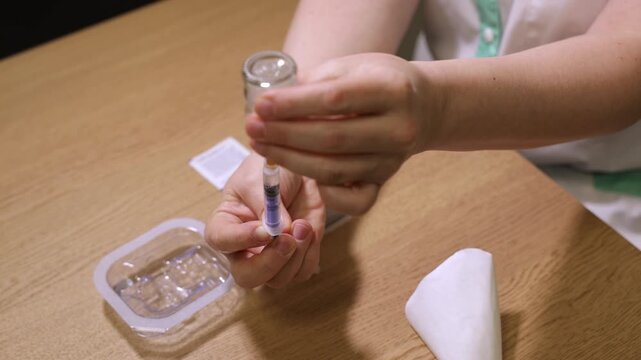 Close up of hands applying medical sensor or patch on skin, healthcare concept