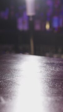 A Captivating Moment: Bartender's Cocktail Creation in Blurry Ambiance