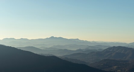 Fototapeta premium Clear weather enhances the outline of multiple hills