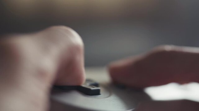 Close-up of Hands Playing Video Game with Classic Retro Controller