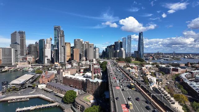 Sydney, Australia: Cinematic panoramic footage of the traffic on the Cahill expressway on the iconic Sydney harbor bridge with the city business skyline in the background in Australia.