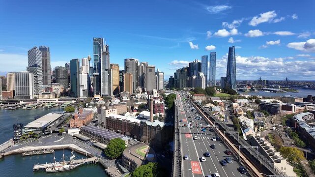 Sydney, Australia: Tilt down footage of the traffic on the Cahill expressway on the iconic Sydney harbor bridge with the city business skyline in the background in Australia.