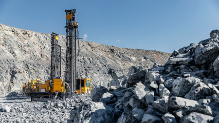 Open pit mine gold ore industry. Massive Mining Dump Truck and Drilling Equipment at Quarry Site © Parilov