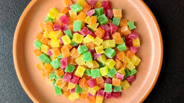 Candied fruit in colorful cubes as an ingredient for baked goods and sweets. Candied fruit as a food background for your design