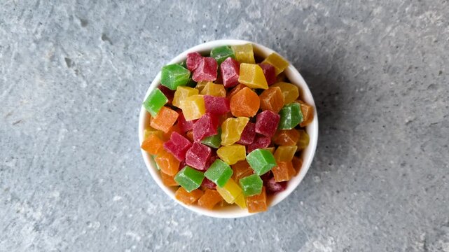 Candied fruit in colorful cubes as an ingredient for baked goods and sweets. Candied fruit as a food background for your design