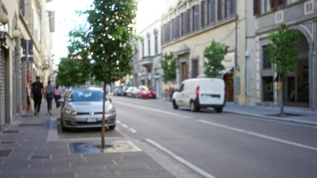 Florence street defocused bokeh background in soft city light; background backdrop copyspace backplate.