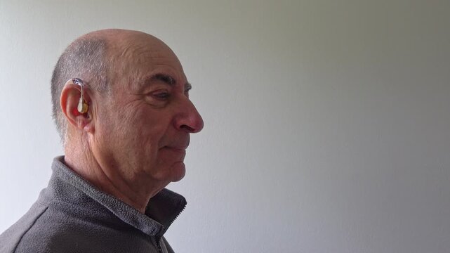 Senior man with visible hearing aid