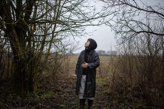 A man in a black leather coat in gloomy weather outdoors in an emotional crisis and sadness