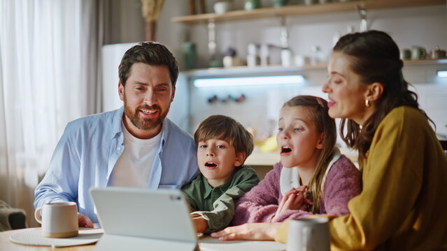 Happy relatives enjoying video call using tablet webcam modern kitchen closeup