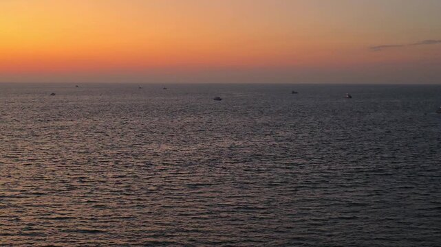 Boats and yachts on the open sea of ​​Acapulco at sunset