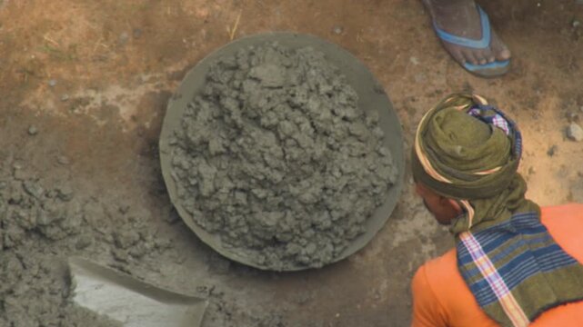Manual residential house construction by workers using traditional methods in Kolkata India