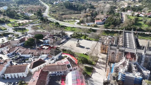 Drone arc orbit around Nuno &Aacute;lvares Pereira statue near Batalha Monastery