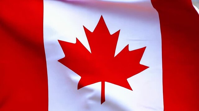 A Vibrant Display of National Identity: Close-Up of the Canadian Flag Featuring the Iconic Maple Leaf Emblem Flapping in the Breeze against a Brilliant Red Background