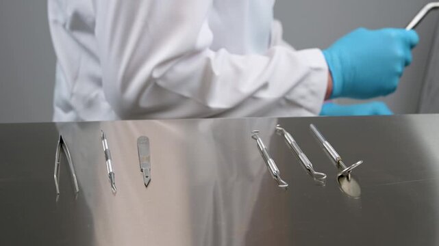 The dentist puts away the instruments for examining teeth and removing them forceps