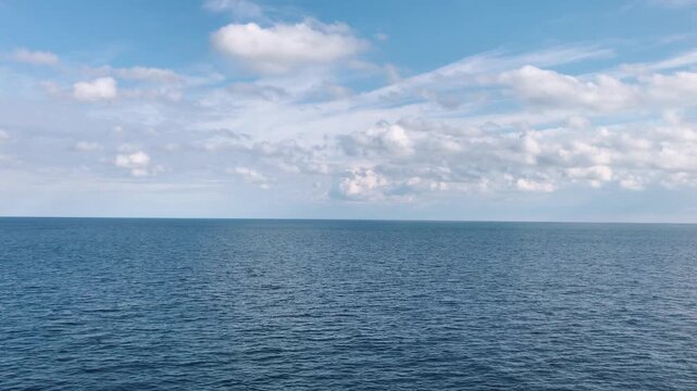 Vertical static video of calm sea view filmed from a floating ferry. Gentle water movement and open horizon create a peaceful atmosphere. Concept of travel, summer, freedom, and relaxing moments on th