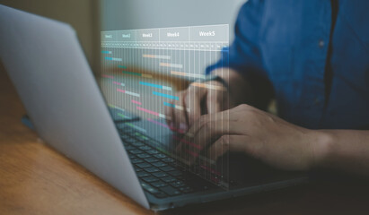 Project management planning with digital timeline schedule interface on laptop computer for business workflow organization