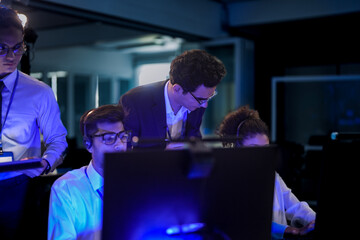 Cybersecurity team monitoring global data threats. Diverse tech professionals analyzing digital...