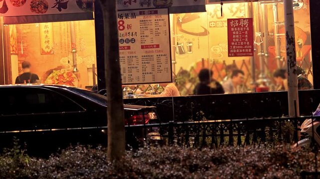 Chinese Restaurant at Night with Warm Glowing Windows and Diners