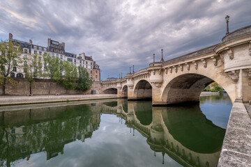 bridge Pont Neuf and Seine river with old houses, Paris, France, toned