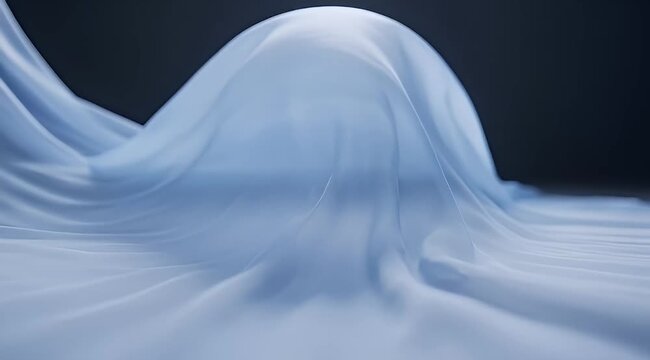 Ethereal draping of translucent fabric on a form against dark background