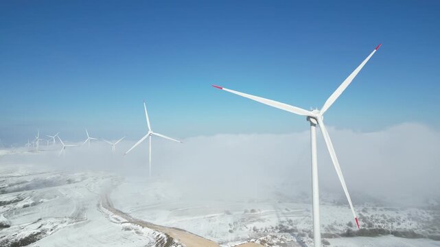 Group of windmills for renewable electric energy production at winter
