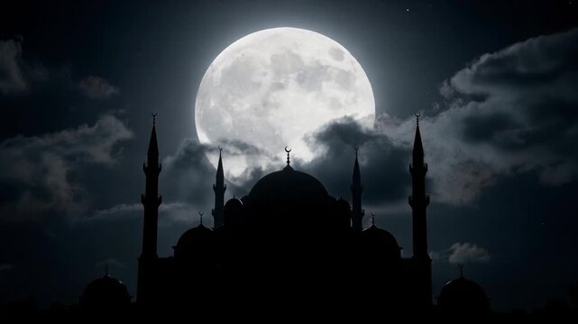 Silhouette of mosque with minarets under bright full moon at night with cloudy sky